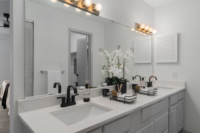 Bathroom featuring a sink, a closet, and double vanity | Image 32