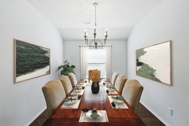 Dining room with wood finished floors, visible vents, baseboards, and a notable chandelier | Image 16