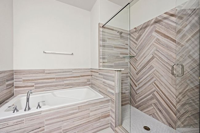 Bathroom featuring a stall shower and a garden tub | Image 23