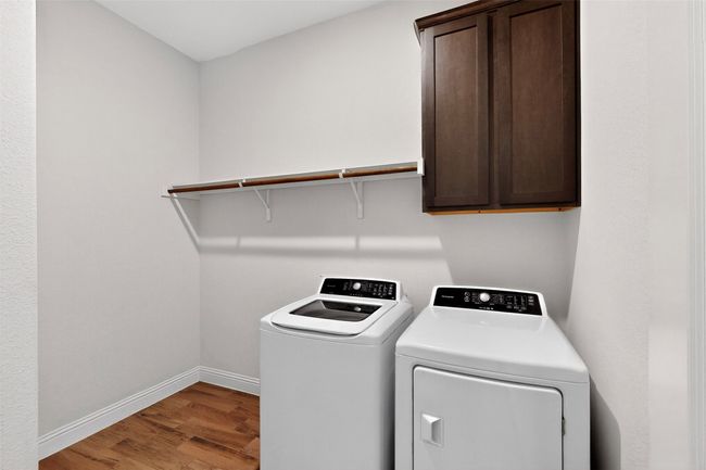 Laundry area with washer and dryer, cabinet space, and wood finished floors | Image 33