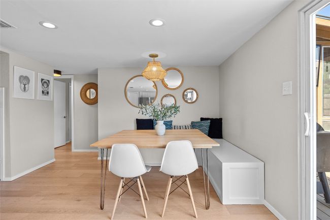 Dining space features built-in bench seating and a beautiful pendant light | Image 14