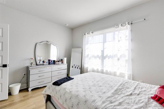 Bedroom with light wood-style flooring | Image 12