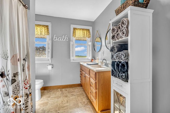 full bathroom featuring baseboards and double vanity | Image 35