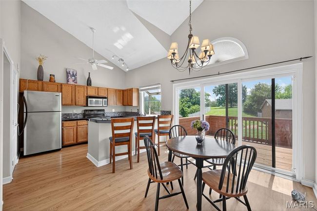 Kitchen with breakfast bar and dining area | Image 15