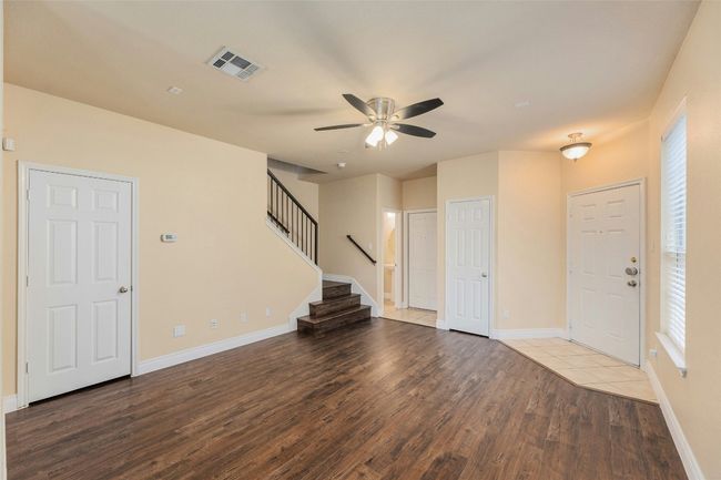 Entryway with wood finished floors, ceiling fan, stairs, and healthy amount of natural light | Image 6