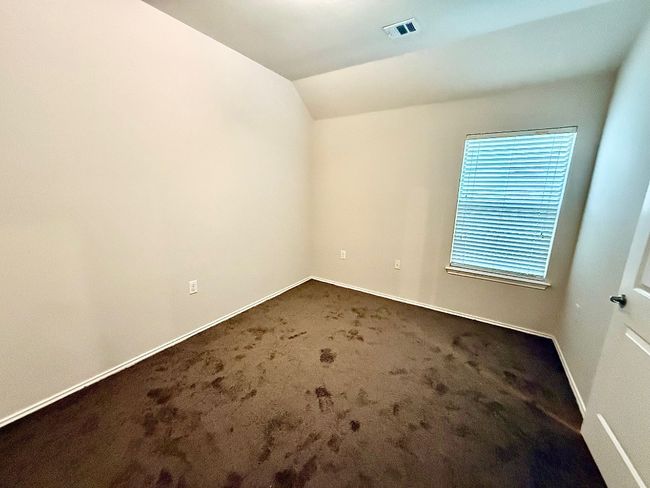Carpeted empty room featuring vaulted ceiling and baseboards | Image 17
