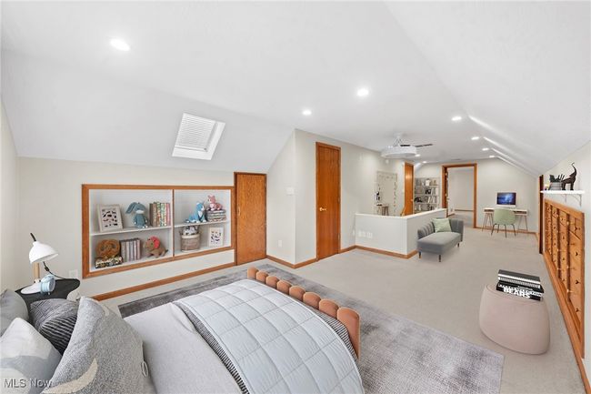 Carpeted bedroom featuring lofted ceiling with skylight | Image 14