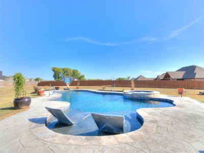 View of swimming pool with an in ground hot tub and a patio area | Image 3