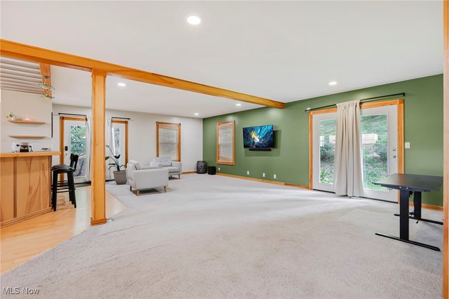 Unfurnished living room with beam ceiling, carpet flooring, and recessed lighting | Image 9