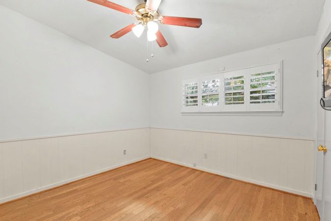 The primary bedroom features a ceiling fan and private en suite for ultimate comfort. | Image 17