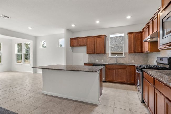 Large kitchen with island and breakfast bar. | Image 4