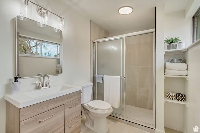 Bathroom featuring a shower stall, toilet, and vanity | Image 13