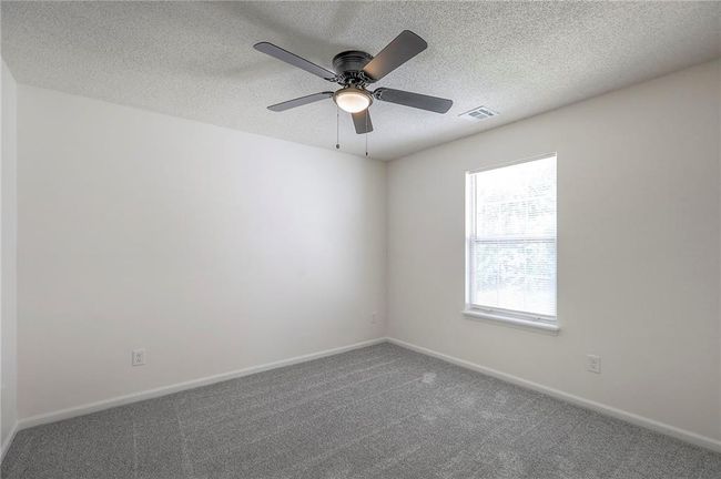 Empty room featuring a textured ceiling and carpet floors | Image 11