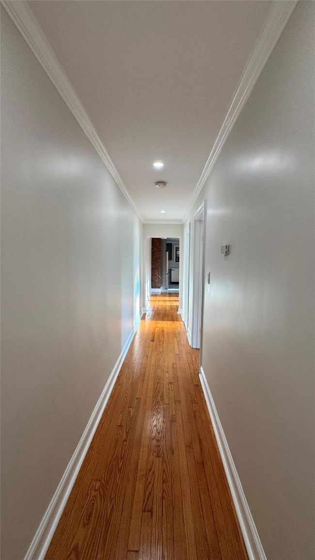 Hallway featuring crown molding and light wood-type flooring | Image 16