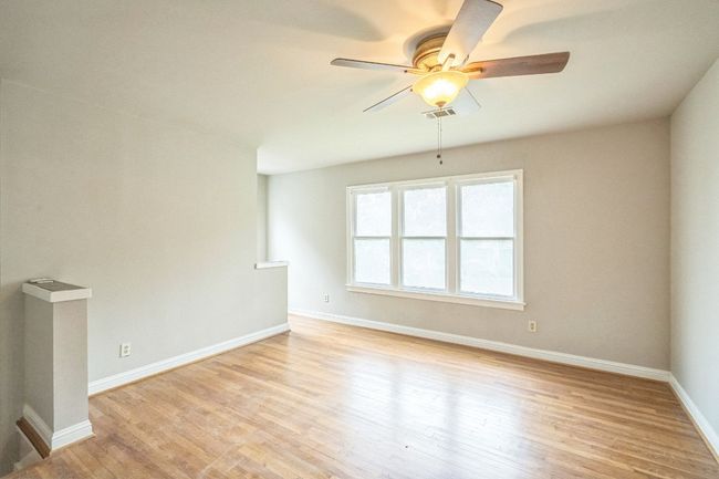 Spare room featuring ceiling fan and light wood-style flooring | Image 13