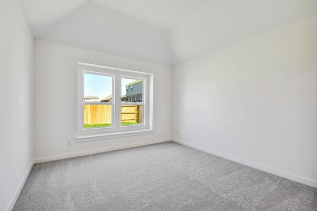Carpeted spare room featuring baseboards and lofted ceiling | Image 13