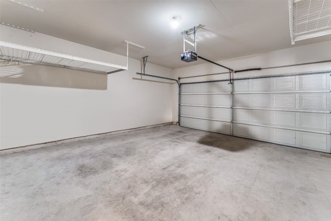 Two car garage with garage door opener and nice overhead storage racks! | Image 24