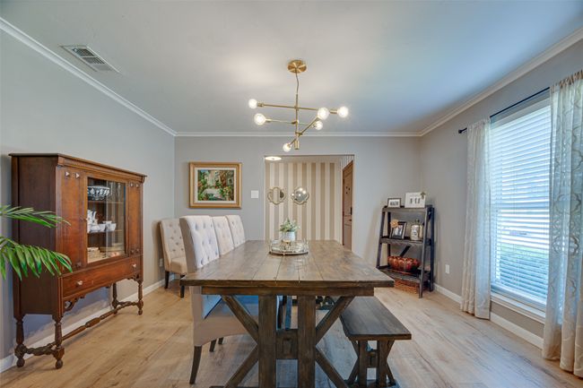 Dining area with a chandelier, light wood-type flooring, and ornamental molding | Image 6