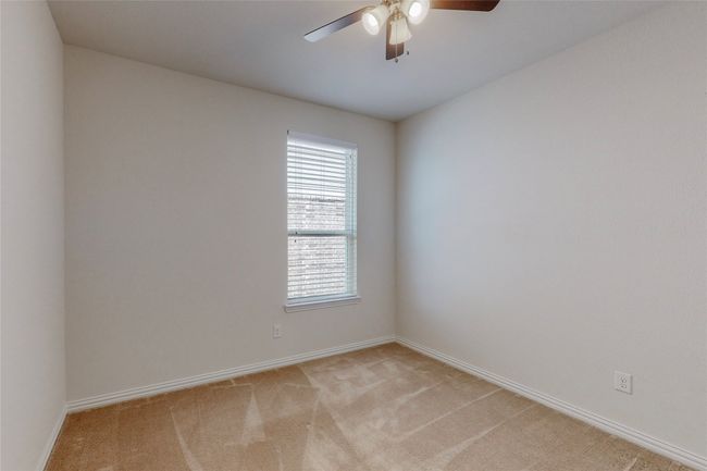 Unfurnished room with light colored carpet, ceiling fan, and baseboards | Image 17