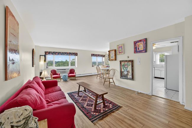 Living room featuring wood finished floors and a ceiling fan | Image 8