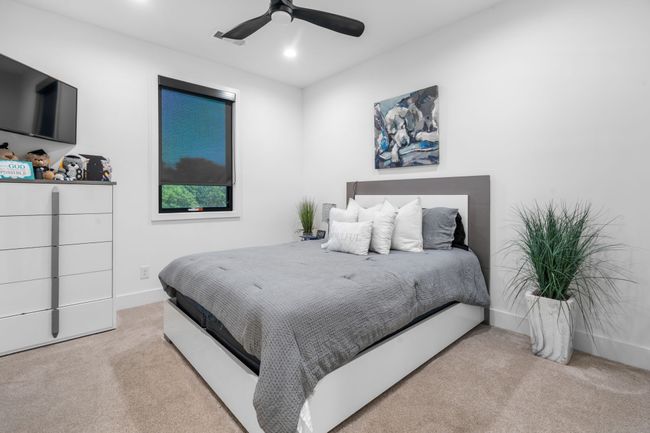 Carpeted bedroom with ceiling fan, baseboards, and recessed lighting | Image 22