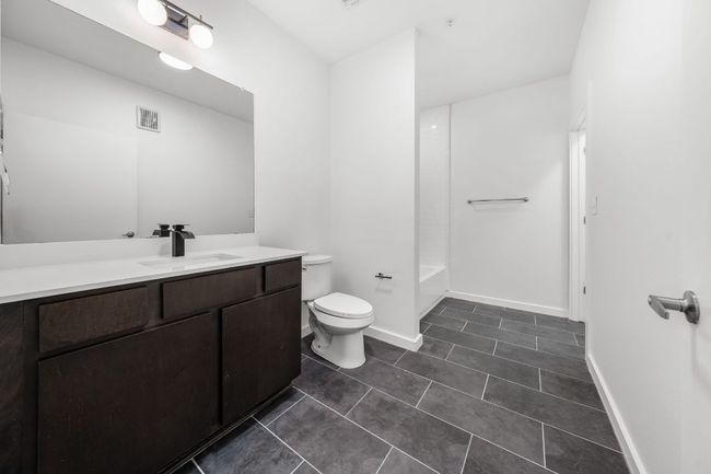 Full bath featuring visible vents, baseboards, toilet, tile patterned floors, and vanity | Image 8