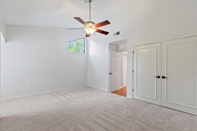 Unfurnished bedroom with carpet flooring, a closet, baseboards, and ceiling fan | Image 23