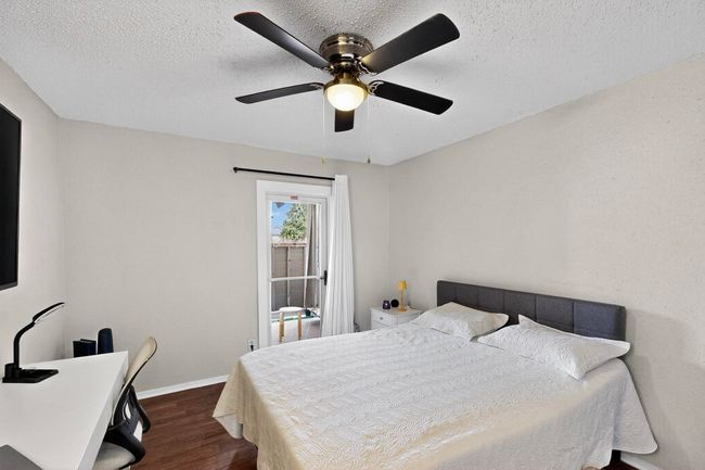Bedroom featuring dark wood finished floors, a textured ceiling, and a ceiling fan | Image 12