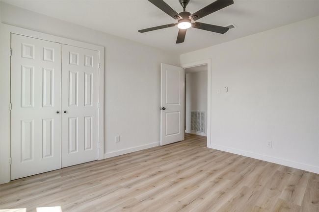 Unfurnished bedroom with light wood finished floors, a closet, and ceiling fan | Image 15