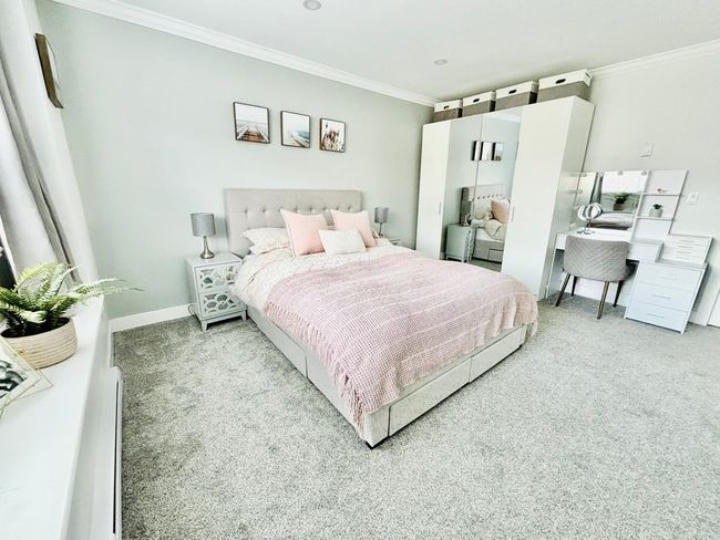 Carpeted bedroom featuring crown molding and baseboards | Image 17