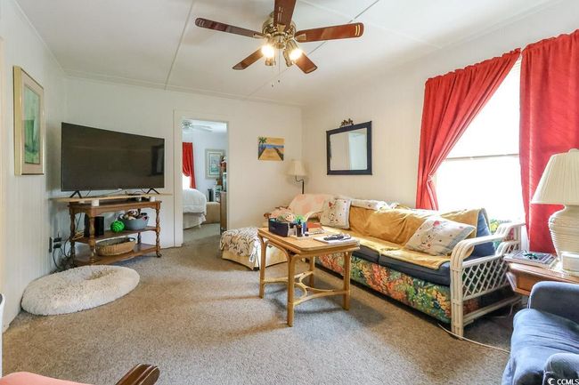 Living room with a ceiling fan and carpet floors | Image 30