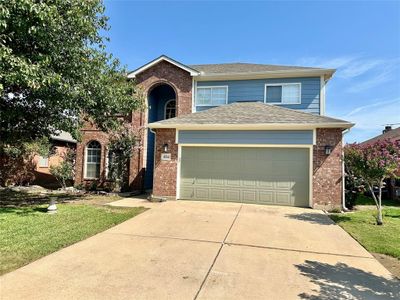 View of front of home with a front lawn and a garage | Image 1