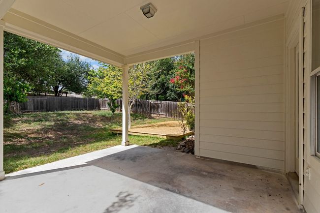 Fenced backyard with a patio | Image 31