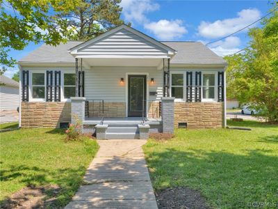 Bungalow-style house with a front lawn | Image 1