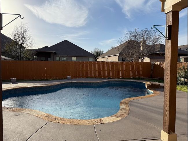 View of swimming pool with great cover patio to enjoy all year around. | Image 37