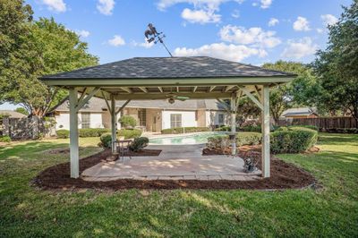 View of patio / terrace with a gazebo, ceiling fan, and a fenced in pool | Image 3