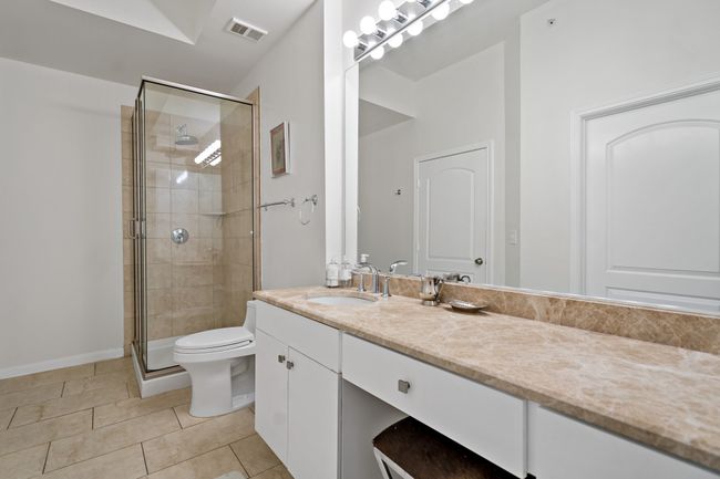 Full bath featuring visible vents, a shower stall, vanity, tile patterned floors, and toilet | Image 16