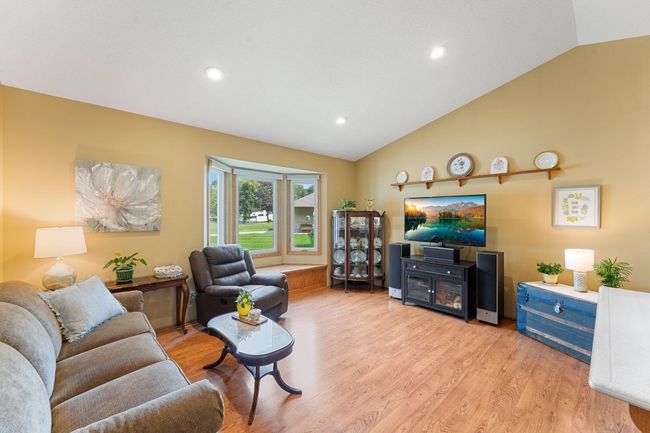 The main floor living room offers a bright, spacious space to gather and enjoy. | Image 8