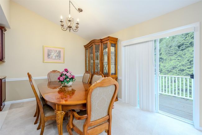 Dining area with a chandelier, vaulted ceiling, and light carpet | Image 10