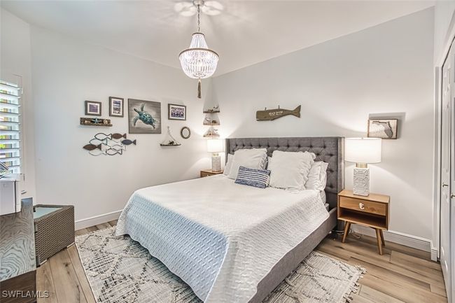Bedroom featuring a chandelier and wood finished floors | Image 38