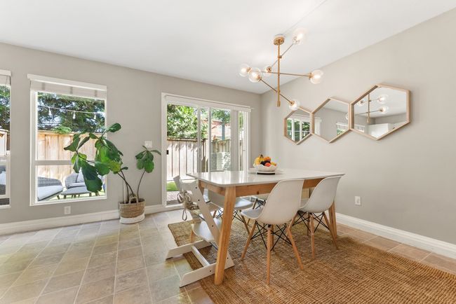 Dining area with a chandelier, baseboards, and light tile patterned floors | Image 15