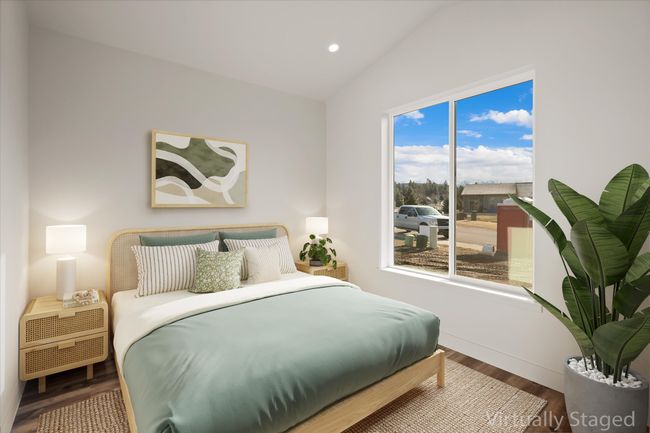 Bedroom with lofted ceiling, wood finished floors, and recessed lighting | Image 7