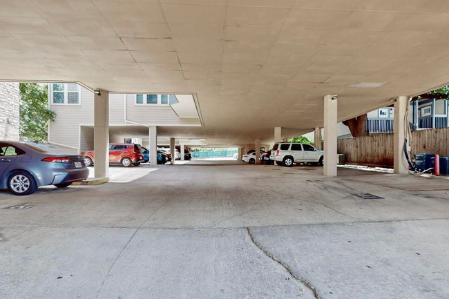 View of parking featuring a parking deck | Image 32
