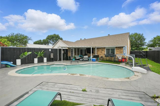 View of pool with a fenced backyard, a deck, a patio area, and an outdoor living space | Image 32