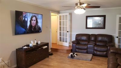 Living room with ornamental molding, ceiling fan, and light hardwood / wood-style floors | Image 3