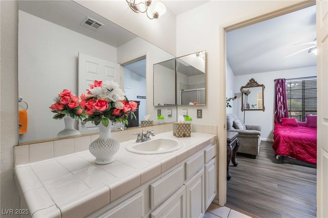 Full bath featuring connected bathroom, ceiling fan, visible vents, wood finished floors, and vanity | Image 30