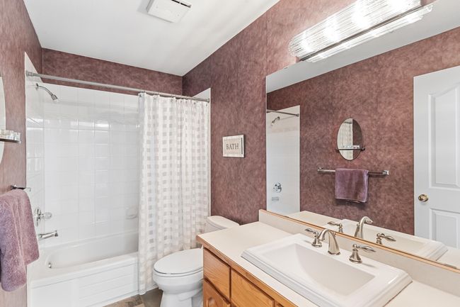 Bathroom with toilet, shower / tub combo with curtain, and vanity | Image 29