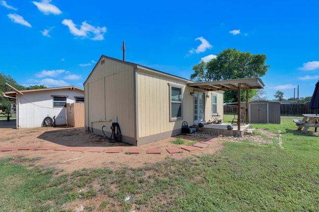 Back of house with a storage shed and a patio | Image 8