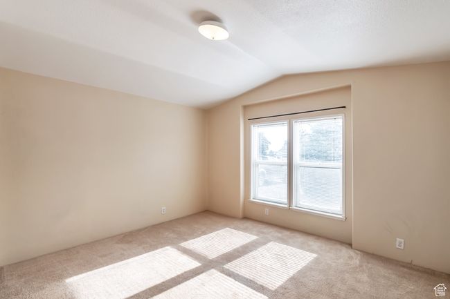 Empty room featuring carpet floors and lofted ceiling | Image 16