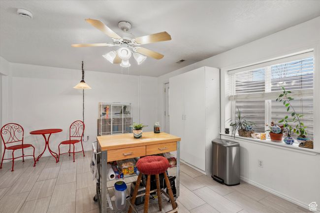 Dining area with baseboards, visible vents, and ceiling fan | Image 21